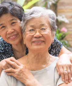 Happy senior friendship society concept. Portrait of Asian female older ageing women smiling with happiness in garden at home, nursing home, or wellbeing county